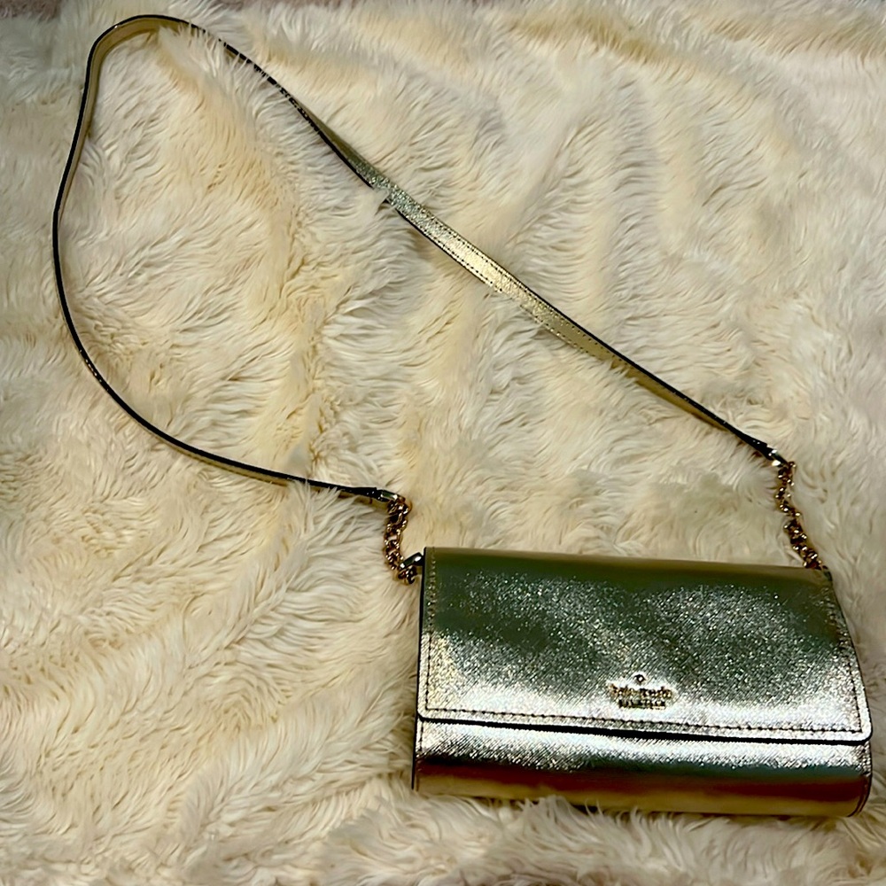 Gold Kate Spade clutch with removable shoulder strap.